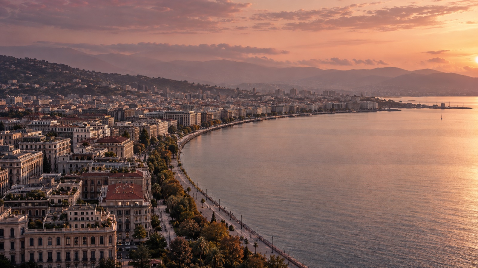 A waterfront city and curved promenade overlooking a broad bay