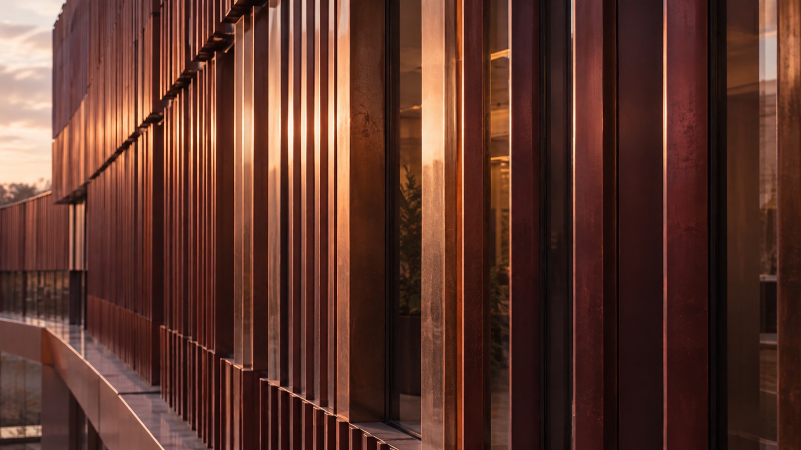 Layered bronze fins and glass creating a repeating architectural pattern